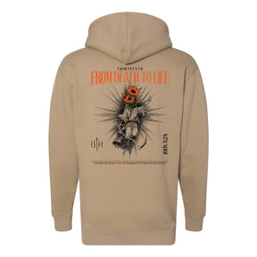 Tan 13th From Death to Life Premium Hoodie with a back graphic of a figure with orange flowers for a head, text reading From Death to Life, and a John 5:24 Bible verse citation.