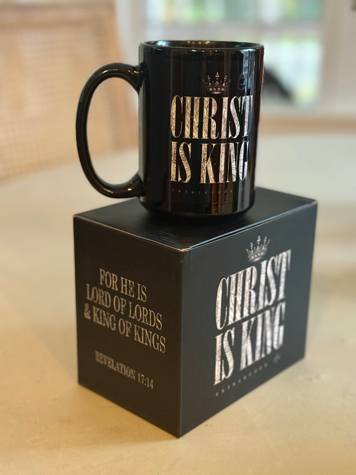 The 13th Christ is King Mug, in black, features the phrase "CHRIST IS KING" and comes in a matching box with "Christ is King" and the verse: "FOR HE IS LORD OF LORDS & KING OF KINGS, REVELATION 17:14" in white text.