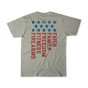 The Foundational Five - Tee by Tango Charlie Apparel is a gray shirt with blue stars and bold red "Faith Family Freedom Fitness Fire Arms" text vertically on the back, styled like a patriotic flag.