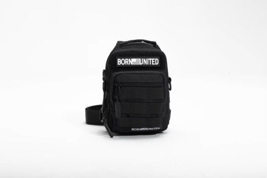 The Born United Private Label Black Phantom Tactical Sling-Pac - 4L is a compact black crossbody bag with "BORN UNITED" in white on both front pockets, displayed on a plain white background—ideal for carrying and organizing essentials.