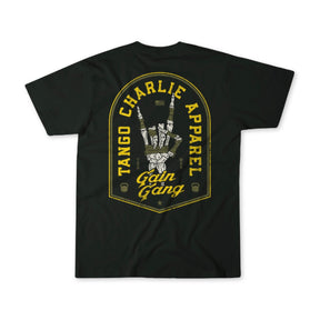 The Gain Gang - Premium Oversized Tee by Tango Charlie Apparel is a black oversized heavyweight shirt with a yellow and white back design featuring "Tango Charlie Apparel" and "Gain Gang," plus an illustrated hand holding a dumbbell.