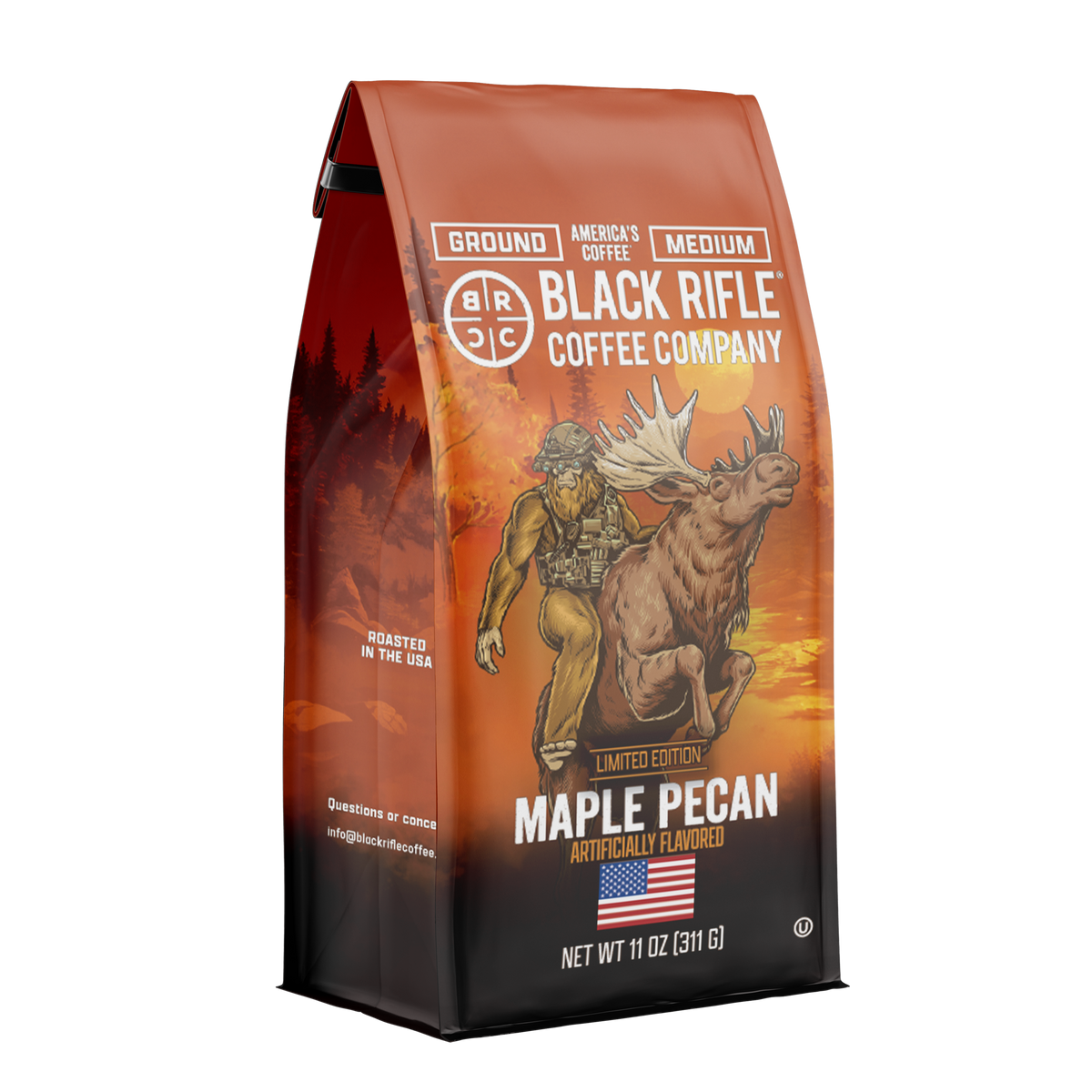 A 12oz bag of Black Rifle Coffee Maple Pecan ground coffee features a muscular man riding a moose on an orange forest background with American flag accents and product details on the packaging.