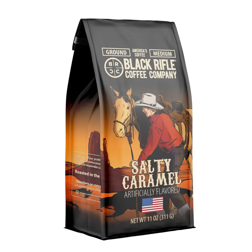 A 12oz bag of Black Rifle Coffee Salty Caramel ground coffee. Medium roast with packaging featuring a cowboy and horse at sunset.