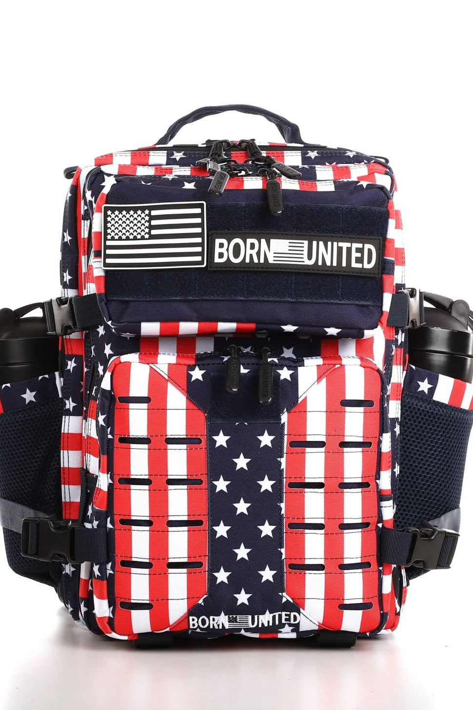 The Ultimate Patriot Special Edition Tac-Pac - 25L from Born United Private Label showcases a bold American flag design with stars and stripes. It features a top flap with patches including Born United. Equipped with side pockets and black straps, it stands out against a plain white background.