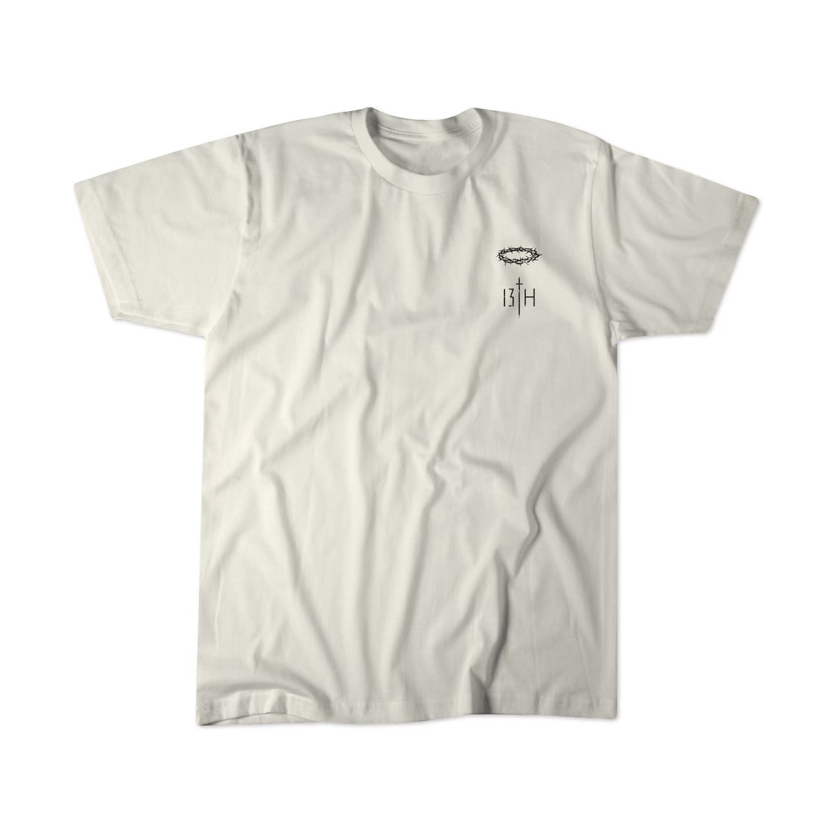 Jesus Saves - White Tee by 13th: A beige T-shirt featuring a small black intricate design and 13TH text on the left chest, displayed against a white background.
