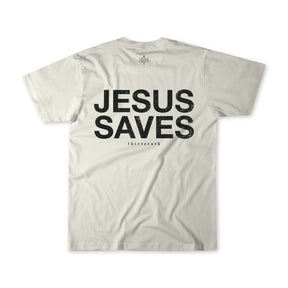 The back of the Jesus Saves - White Tee by 13th displays bold black JESUS SAVES text with smaller thierrenh below it, set on a plain background.