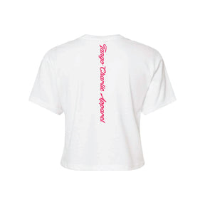 The Feral Crop Tee - White by Tango Charlie Apparel is a white short-sleeve cotton-poly blend, seen from the back with "Tango Charlie Apparel" printed vertically in bold red script down the center.