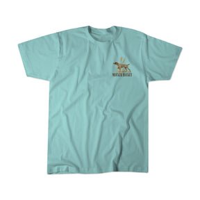A light blue, ring-spun cotton t-shirt from Mucker Bucket featuring a small graphic of a dog and the text "Dog DNA Premium Tee" on the left chest area.