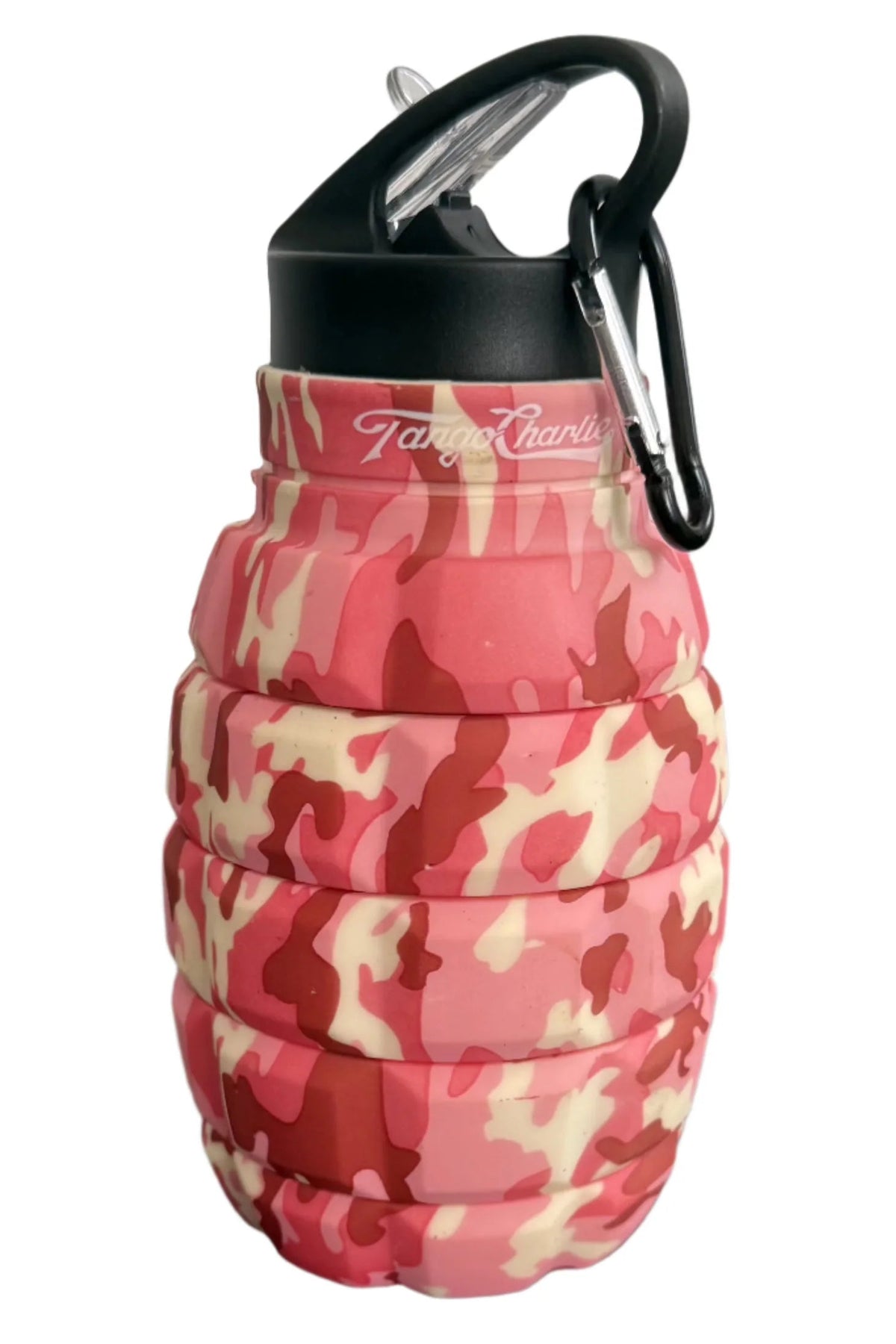 The Pink Camo Humble + Hydrated 20oz Water Bottle by Tango Charlie Apparel is a grenade-shaped, collapsible bottle made from BPA-free food-grade silicone, featuring a pink camo pattern, black cap, and carabiner.