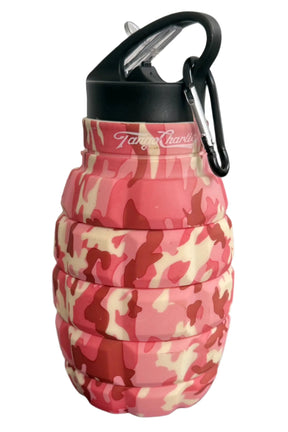 The Pink Camo Humble + Hydrated 20oz Water Bottle by Tango Charlie Apparel is a grenade-shaped, collapsible bottle made from BPA-free food-grade silicone, featuring a pink camo pattern, black cap, and carabiner.
