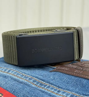 Green ratchet belt on a pair of denim jeans

