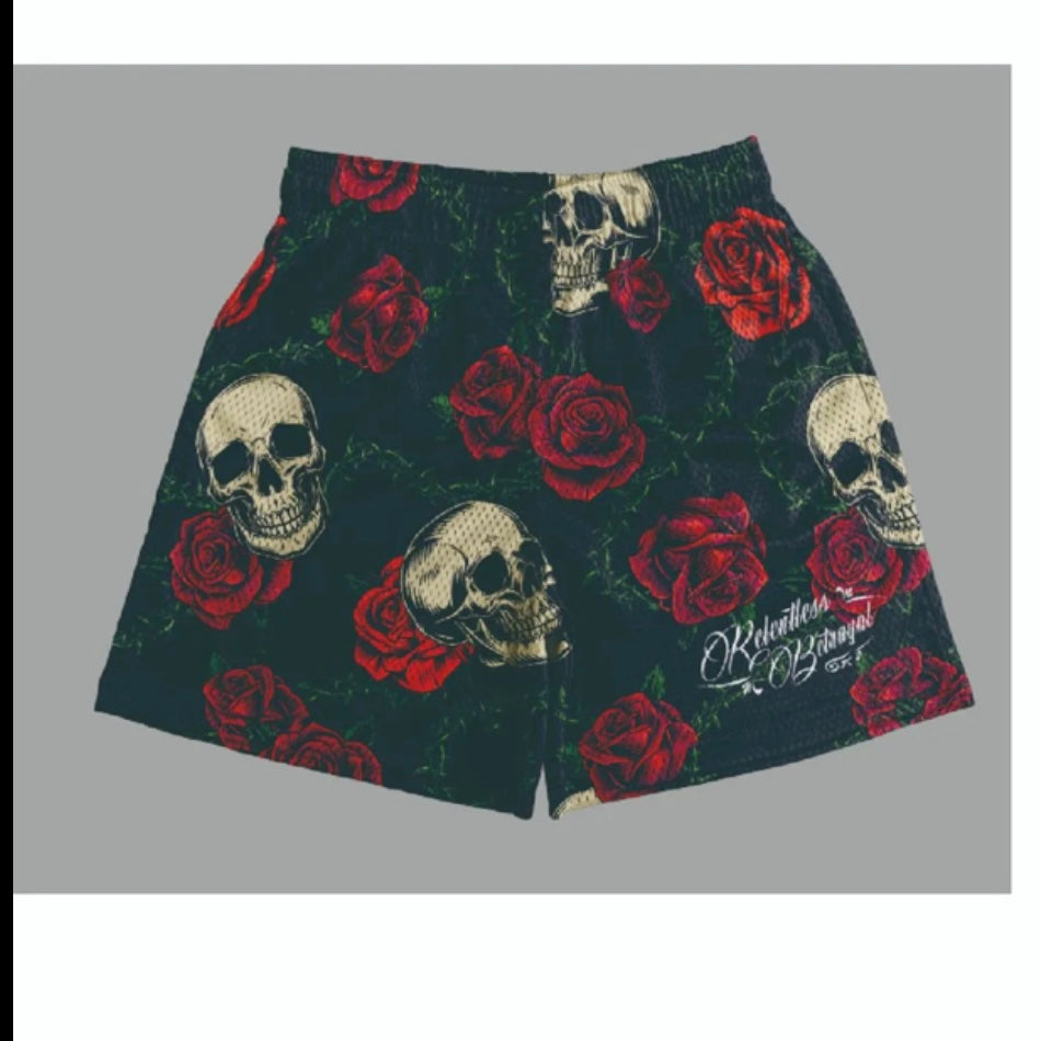 The Relentless Betrayal Premium Mesh Shorts | 5- Thorn Amongst Roses are black unisex gym shorts with red rose and white skull patterns plus stylized white text on one leg, shown on a plain gray background.