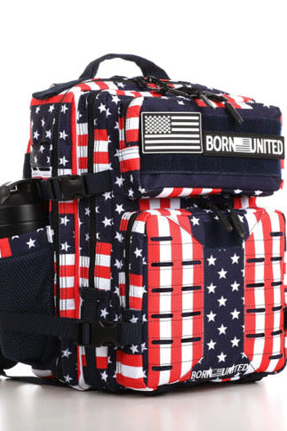 The Ultimate Patriot Special Edition Tac-Pac by Born United Private Label is a 25L backpack with an American flag design in red, white, and blue. It has multiple compartments, a side pocket for a water bottle, and BORN UNITED displayed on the front.