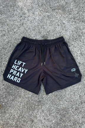 Tango Charlie Apparel’s Men’s Mesh Lifestyle Shorts | 5.5"- Lift Heavy Pray Hard Black feature "LIFT HEAVY PRAY HARD" on the left leg and small right-side logos, perfect for your active lifestyle.