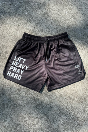 Tango Charlie Apparel’s Men's Mesh Lifestyle Shorts | 5.5"—Lift Heavy Pray Hard Black—feature bold white text and logos, combining comfort and style for your active lifestyle.