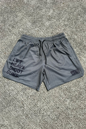 Men's Mesh Lifestyle Shorts | 5.5"- LHSG OD Green by Tango Charlie Apparel, featuring "LIFT HEAVY. SHOOT GUNS." in bold print on the left leg and a small SAVAGE UNITED logo on the right—perfect lifestyle athletic shorts.