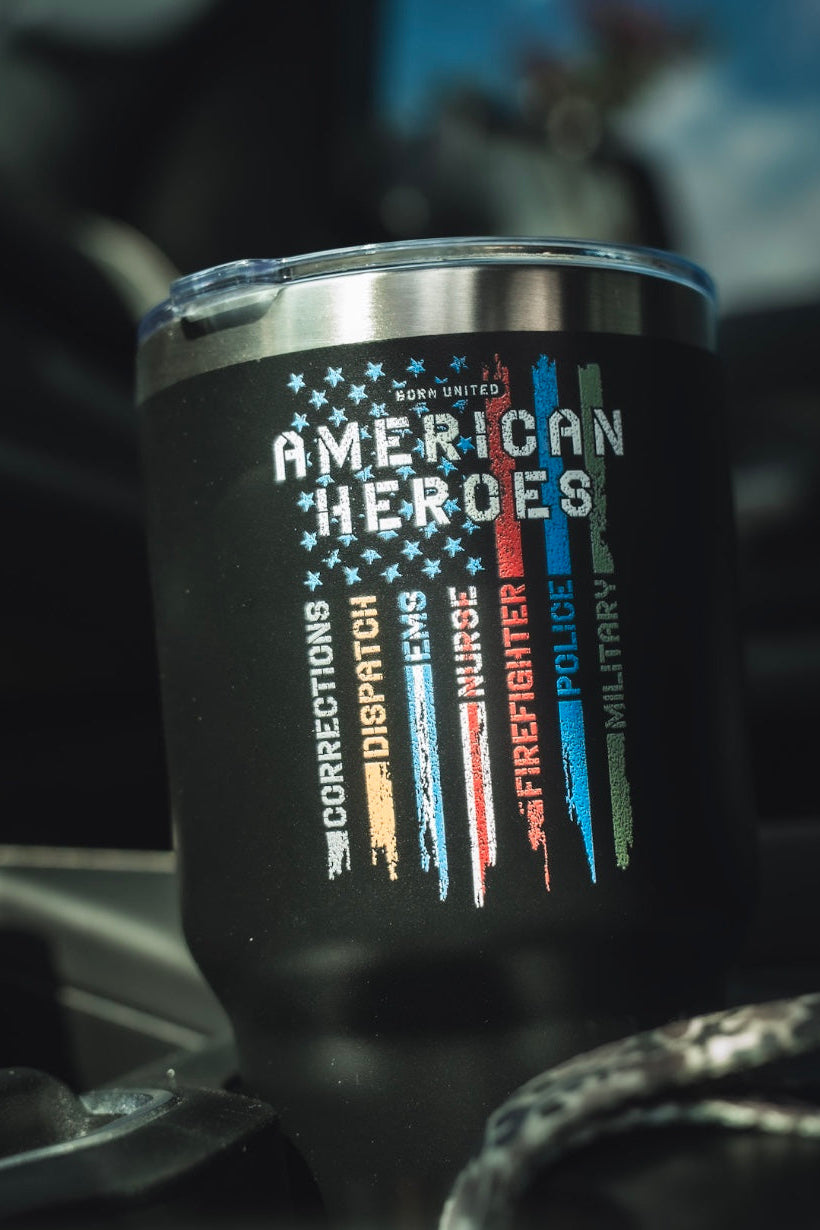 The Born United Private Label American Heroes Tumbler - 30oz is black with a distressed American flag design, colored stripes, and words for Corrections, Dispatch, EMS, Firefighter, Police, and Military.