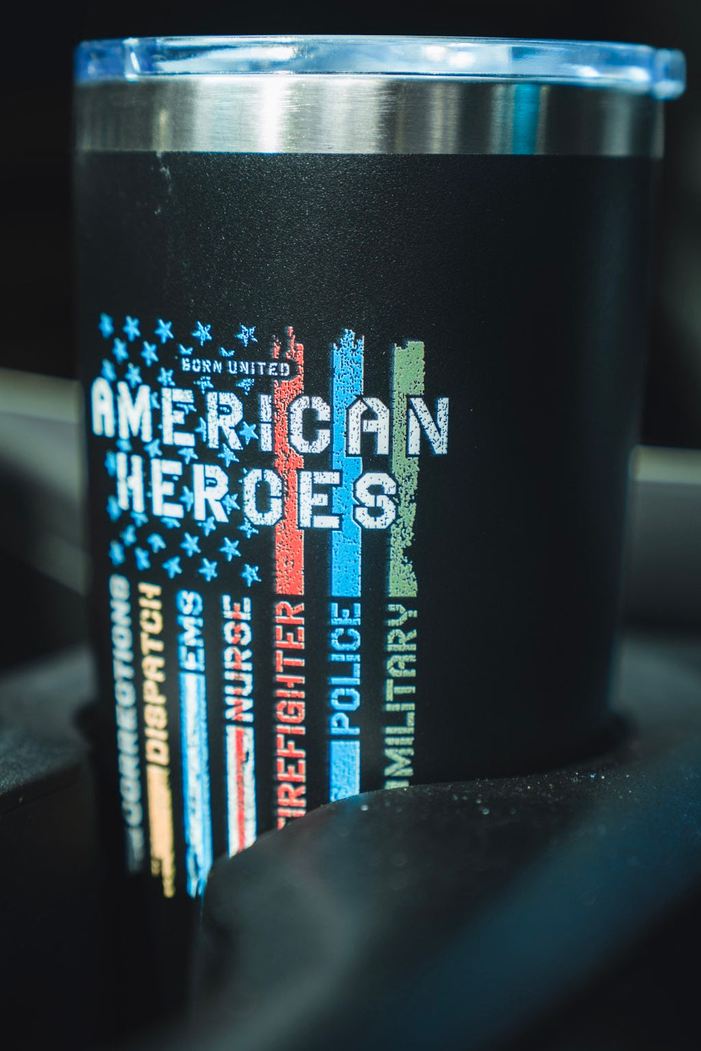 Display your pride with the Born United American Heroes Tumbler - 20oz, featuring a distressed flag with colored stripes honoring corrections, dispatch, EMS, nurses, firefighters, police, and military heroes.