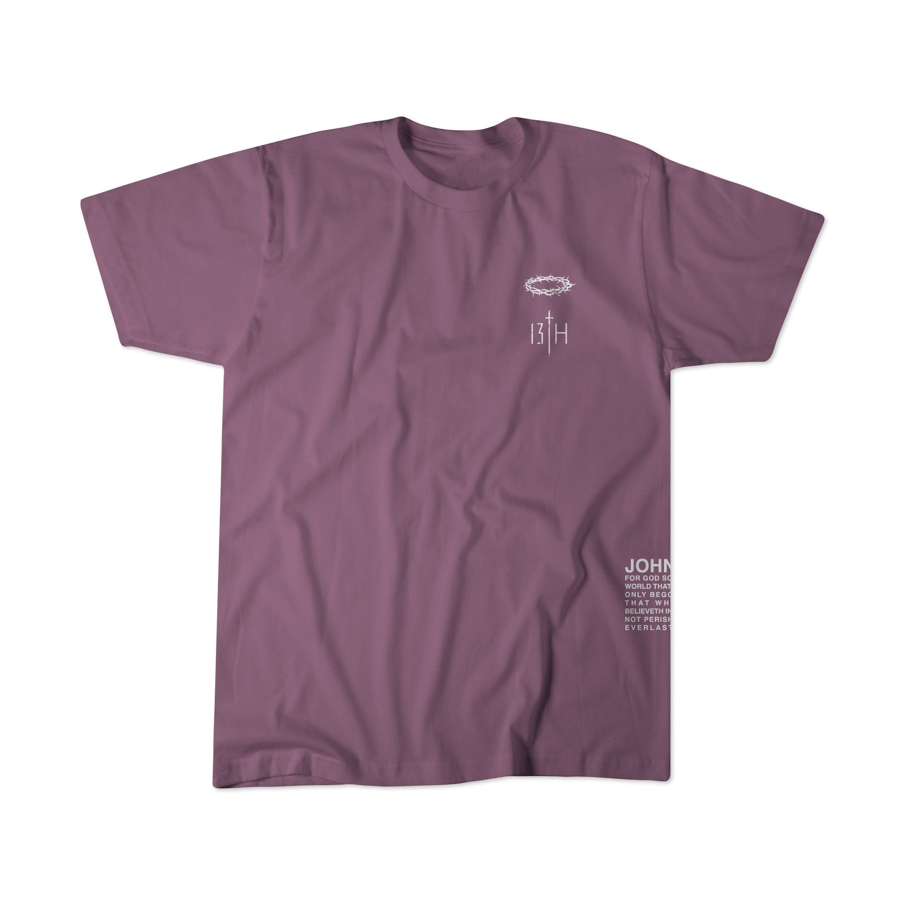 The Jesus Saves Berry Tee by 13th is a mauve short-sleeve crew neck shirt featuring small white graphic text on the left chest and lower right side, with no other visible designs or patterns.