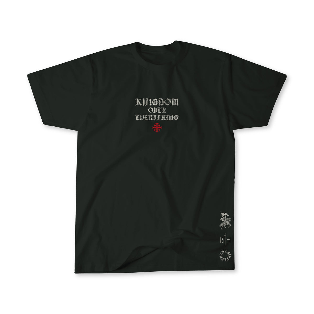 The Kingdom Over Everything Premium Tee by 13th features KINGDOM OVER EVERYTHING in white gothic font, a red cross below the text, small white graphics, and “13/4” near the lower right hem, inspired by Matthew 6:33.
