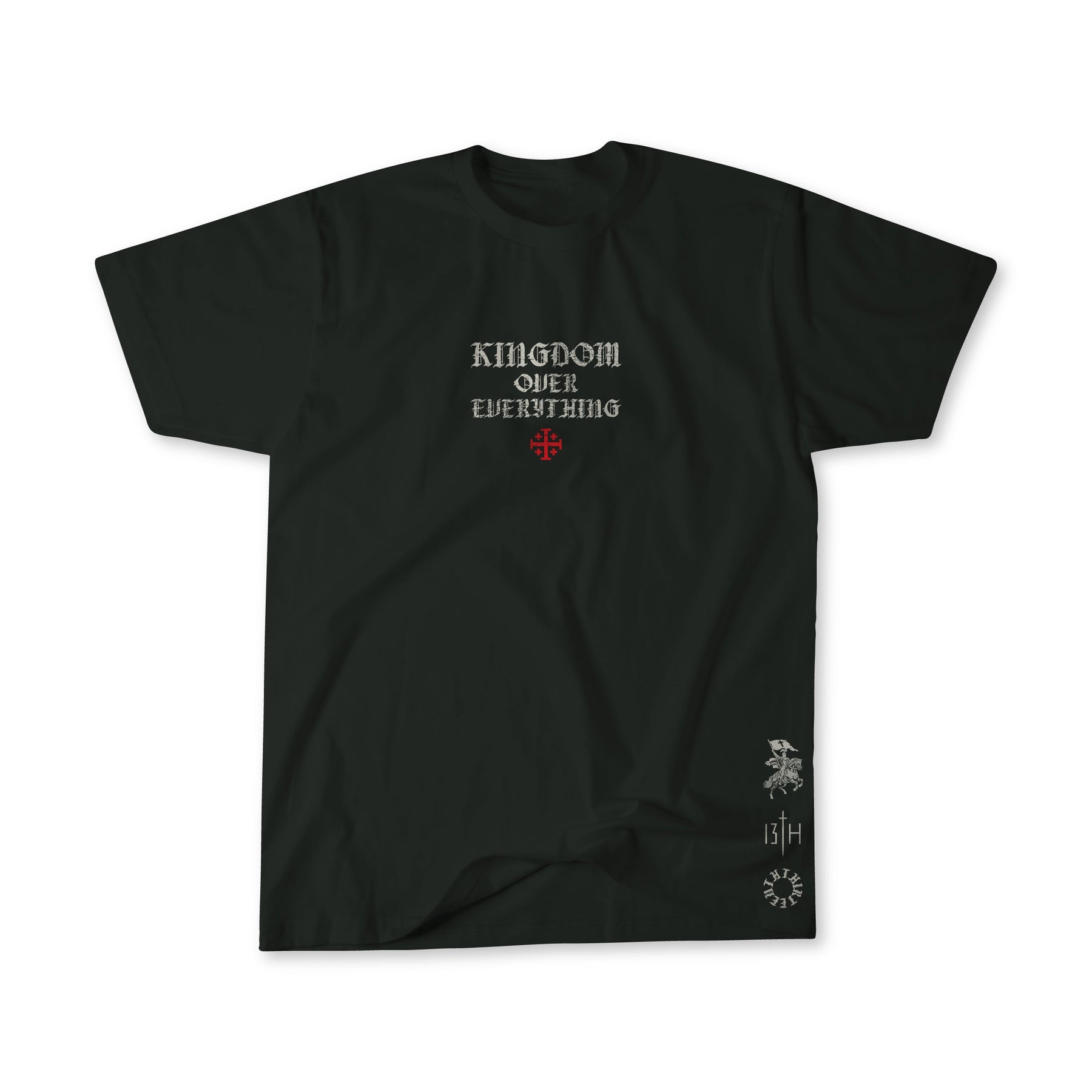 The Kingdom Over Everything Premium Tee by 13th features KINGDOM OVER EVERYTHING in white gothic font, a red cross below the text, small white graphics, and “13/4” near the lower right hem, inspired by Matthew 6:33.