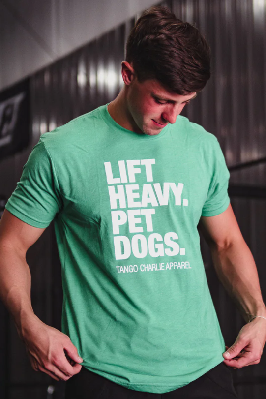 Man wearing a green t-shirt with 'Lift Heavy, Pet Dogs' text in a gym setting