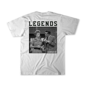 The Born United Private Label Legends - Honey Im Home! T-shirt features a black-and-white photo of a surprised woman and a man talking, with LEGENDS in bold above and BORN UNITED printed in the corner.