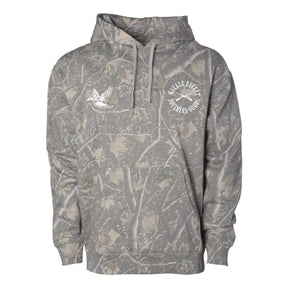 The Mucker Bucket Mallard Deadwood Camo Hoodie features a premium relaxed fit, front pocket, white drawstrings, and two chest logos—one with circular text and the other with a flying duck.