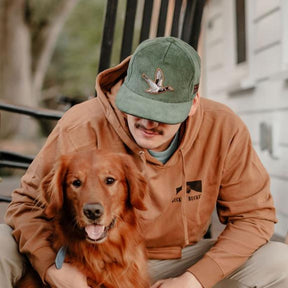 mucker bucket - duck green corduroy hat on model front