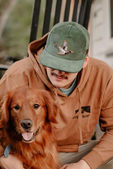 mucker bucket - duck green corduroy hat on model front