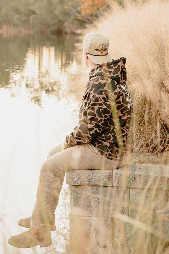 mucker bucket - wood duck camo hooded sweatshirt on model