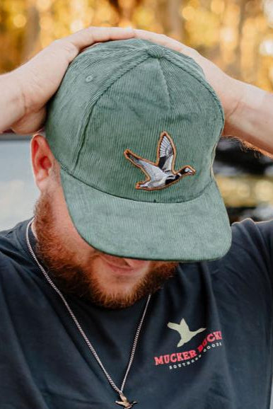mucker bucket - duck green corduroy hat on model