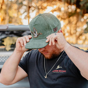 mucker bucket - embroidered duck green corduroy hat on model