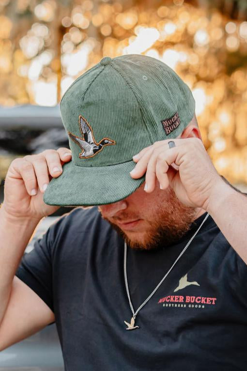 mucker bucket - embroidered duck green corduroy hat on model