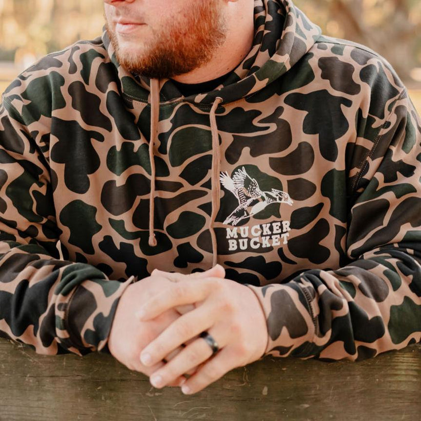 mucker bucket - wood duck camo hoodie front on model