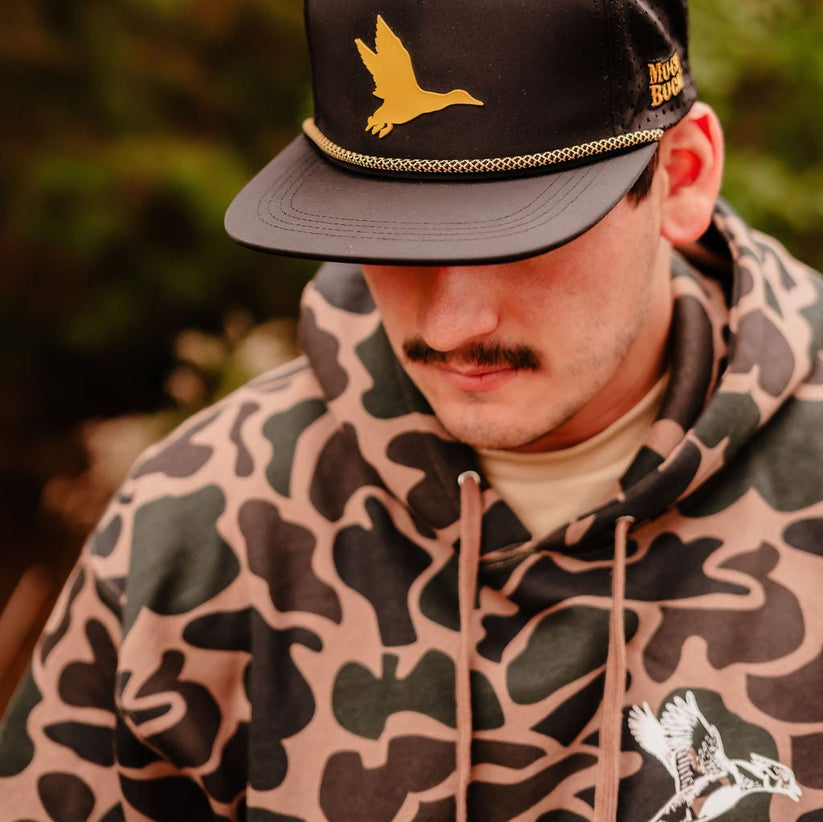 mucker bucket - wood duck camouflage hooded sweatshirt on model