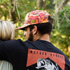 mucker bucket - chasin' tail fall camo snapback hat on model