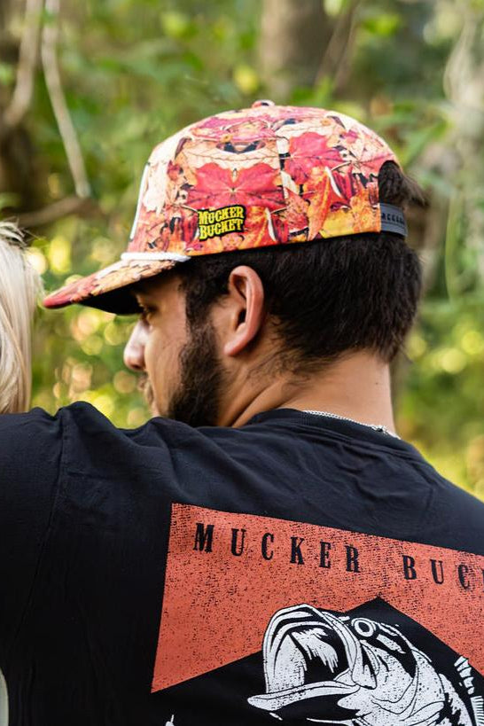 mucker bucket - chasin' tail fall camo snapback hat on model
