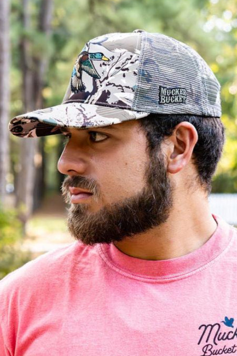 mucker bucket - mallard big woods camo trucker hat on model