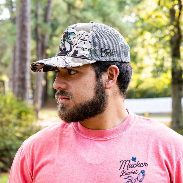 mucker bucket - mallard big woods camo trucker hat on model