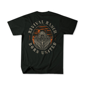 The Revival Ranch Premium Tee from Born United Private Label features a black base with a graphic of a barn and sunset framed by distressed "Revival Ranch Born United" text on the back. This Christian apparel piece seamlessly combines rustic appeal with faith-inspired ranch design.