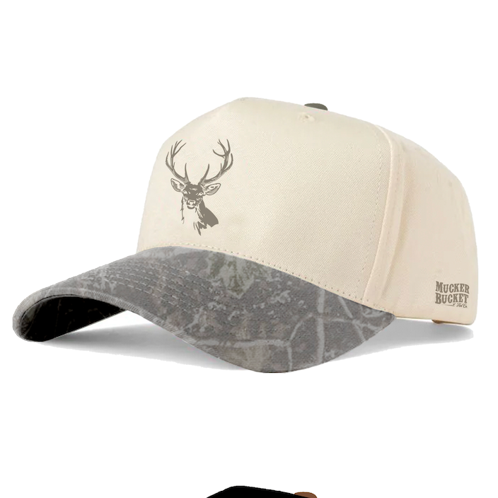 Beige Buck Master Deadwood Bucket cap by Mucker Bucket, featuring a gray camo-patterned brim, stag head graphic on the front, and MUCKER BUCKET text on the side. This high-profile snapback combines classic style with modern details for a standout look—perfect for fans of Buck Embroidery Snapback designs.