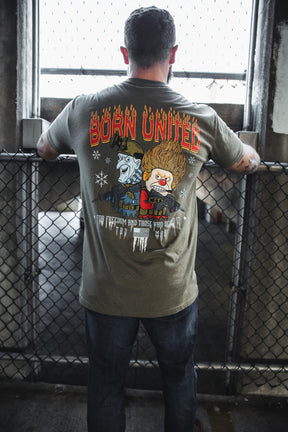 A man faces away, wearing a Born United Private Label "Tactical Miser Operations" T-shirt with cartoon characters—one blue-skinned, one with flaming hair—and the phrases "BORN UNITED" and "FOR THE FREEDOM AND THOSE WHO DEFEND IT.