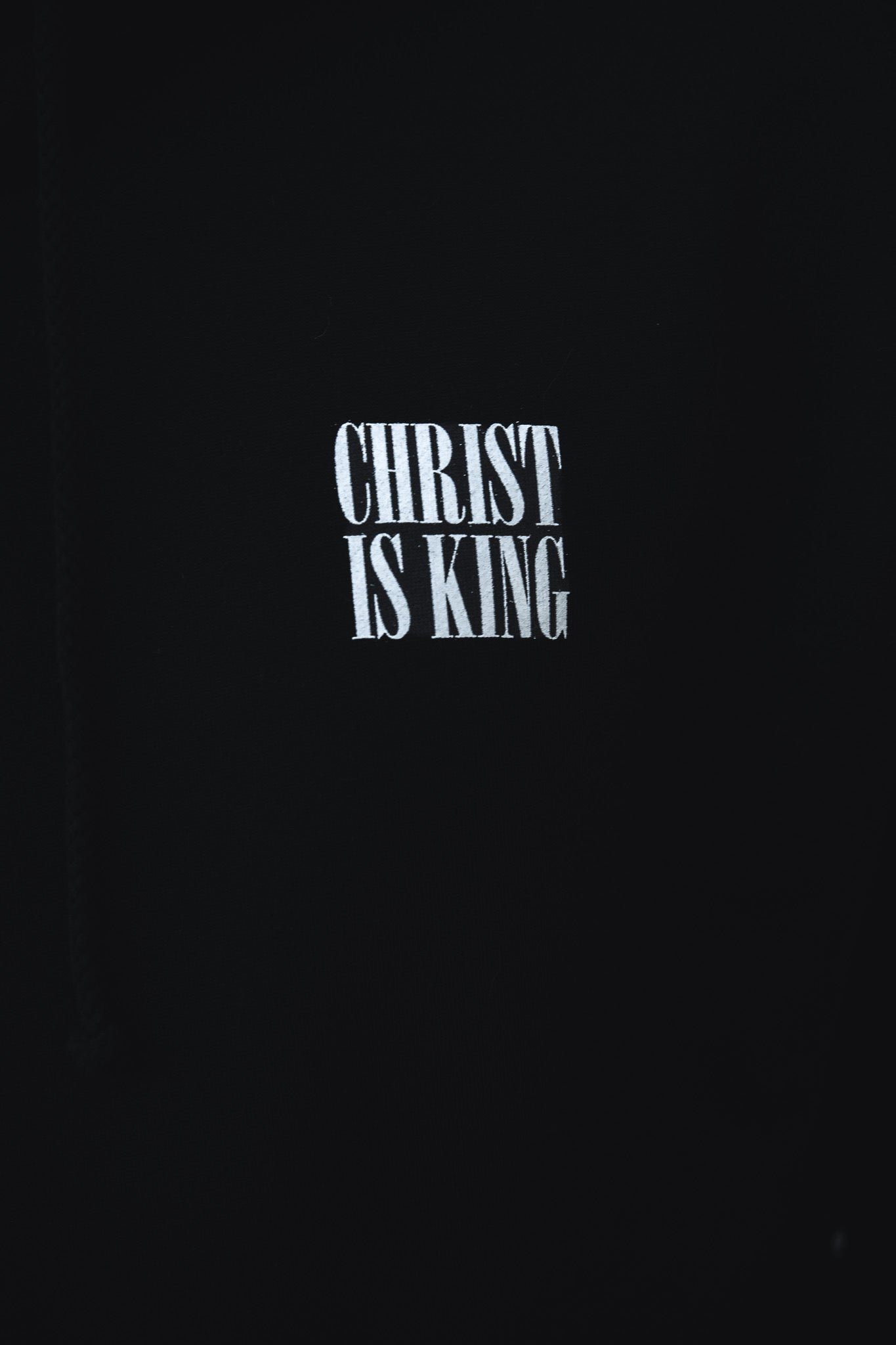 White “CHRIST IS KING” text stands out on the black Christ is King Premium Hoodie by 13th, making it a bold statement of faith.