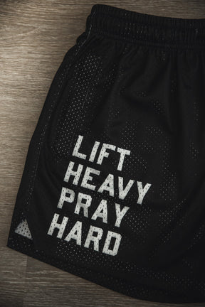 Tango Charlie Apparel Men's Mesh Lifestyle Shorts | 5.5"—"Lift Heavy Pray Hard" black shorts with white text, ideal for active routines.