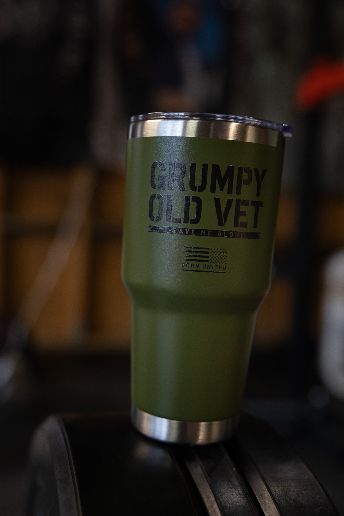 The Grumpy Old Vet Tumbler - 30oz by Born United Private Label features a sleek green and silver design, perfect for keeping your drinks at the ideal temperature.