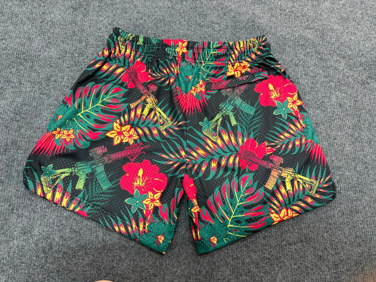 Tango Charlie Apparel Men's Mesh Lifestyle Shorts | 5.5" - Tropical Assassin feature a vibrant tropical pattern with palm leaves, flowers, and rifles on a dark background. Quick-dry and stylish—ideal for your active lifestyle.