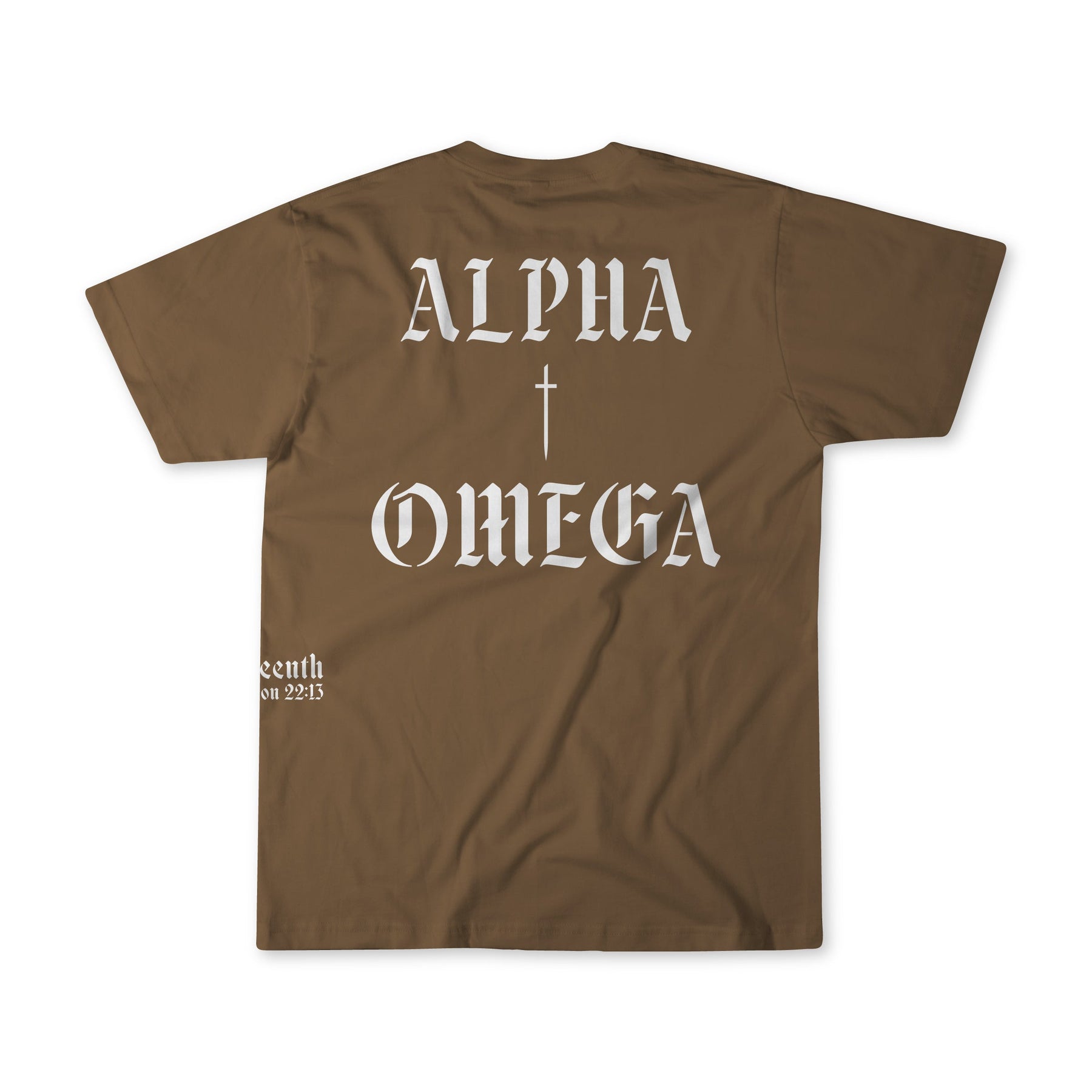 The 13th Alpha Omega Premium Tee in tan features ALPHA above a cross and OMEGA below it in white gothic lettering on the back, with small white text near the bottom left.