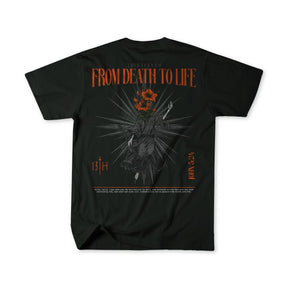 The From Death To Life Premium Tee by 13th features FROM DEATH TO LIFE in bold orange on black. It showcases a hand holding a red flower among spikes symbolizing eternal life, with THIRTEENTH, 13TH, and the verse JOHN 5:24 included.