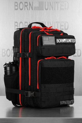 Black and red backpack with 'Born United' branding on a metallic surface.